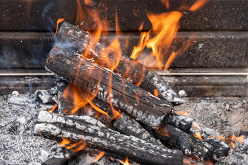 Burning wood to coal on barbeque 