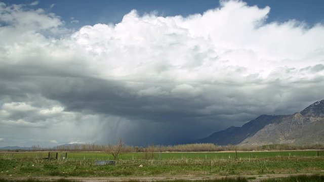 Time lapse of storm moving over the landscape against the mountains in Utah Valley.
