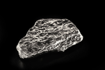 tin stone on black isolated background. Industrial application ore.