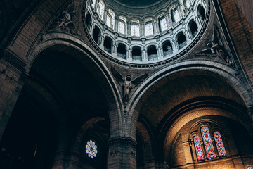 interior of a cathedral, view to the ceiling. Detail of the arches and light entrances. Dark and contrasting photography with details and texture