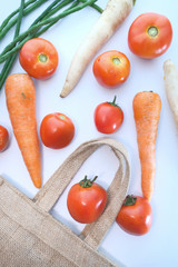 fresh vegetables spilling from shopping bag, top view 