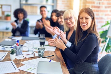 Group of business workers smiling happy and confident. Working together with smile on face looking at the camera applauding at the office