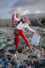 Modern woman on landfill, consumerism versus pollution concept.