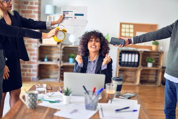 Group of business workers working together. Partners stressing one of them at the office