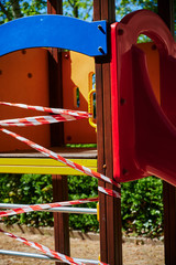 Children's playground in Berlin, Germany, which was closed due to the Covid-19 virus and the blocking of contact with a barrier tape.