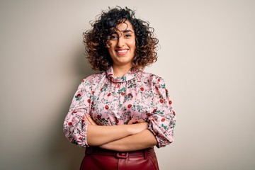 Young beautiful curly arab woman wearing floral t-shirt standing over isolated white background...