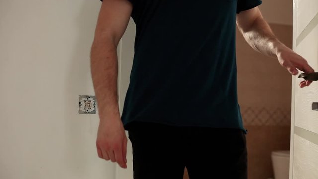 Man comes out of the toilet and closes the door.