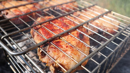 Pork steaks cooked on a charcoal grill outdoors