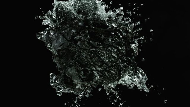 Piece of coal with water splashing. Cosmetic concept of skin and face care. Filmed on super slow motion camera, 1000 fps.