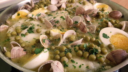 Hake dish in green sauce with clams