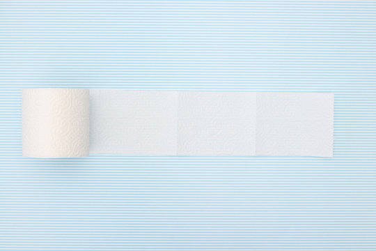 Unrolled Toilet Paper On  Blue  Background 