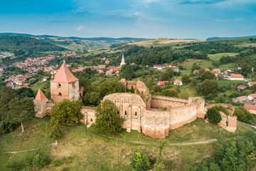 Aerial drone view of Slimnic Fortress (Stolzenburg), located on a Burgbasch hill in  Sibiu region, Romania