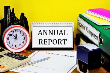 Annual report-text label on the calendar. There are folders with accounting documents on the...