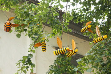 The idea of crafts for children, crafts with children, a reusable bottle for water. Bees on a tree made of plastic bottles. Recycling Plastic Waste - 341051064
