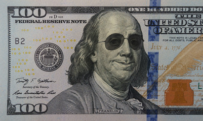 Happy smiling president Franklin portrait wearing sunglasses on 100 dollar bill. Concept of economic growth - obrazy, fototapety, plakaty