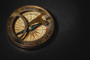 Retro compass on black board background.