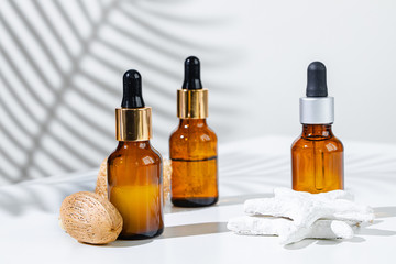 Skincare products containers on a white background with creative shadows close up