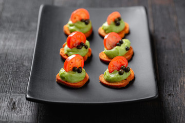 mini catering canapes with guacamole and cherry tomato