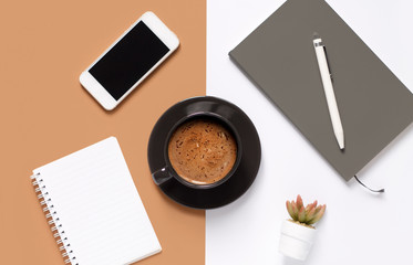 Minimal work space-flatley Top view creative office Desk with notebooks, pen, phone and coffee Cup on a white and brown background. Panorama banner