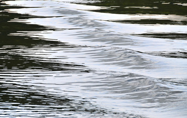 Waterscape with the contrast waves: blue glimpses on the lake. The sequence of embossed waves under dim sky lighting; a series of images, No.3