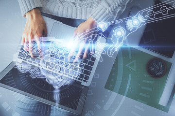 Double exposure of woman working on computer andhuman brain hologram drawing. Top View. Ai concept.