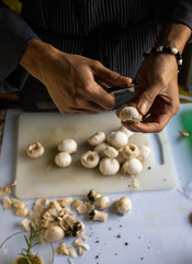 Obraz na płótnie Canvas close up chef cutting and cleaning mushrooms