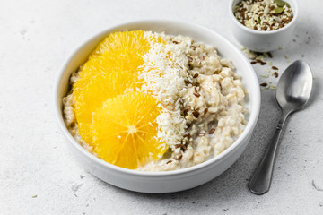 Breakfast bowls, coconut citrus oatmeal. Selective focus, copy space.