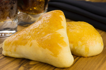 Syrian-Lebanese pie stuffed with meat called sfiha in a cutting board in black background