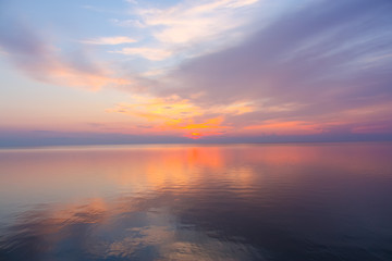 Fototapeta na wymiar Inspirational calm sea with sunset sky. Meditation ocean and sky background. Colorful horizon over the water