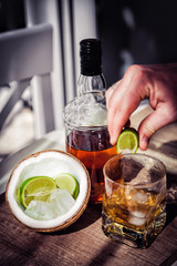 Rum with ice and coconut, a bottle of rum with lime
