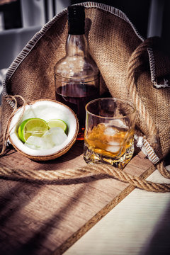 Rum with ice and coconut, a bottle of rum with lime