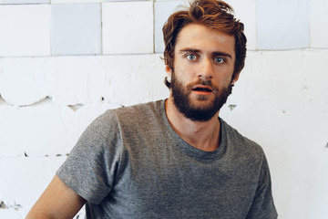 Portrait of Expressive young  bearded man scared and nervous