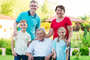 Portrait of big happy family with old grandfather, his daughter and his grandchildren