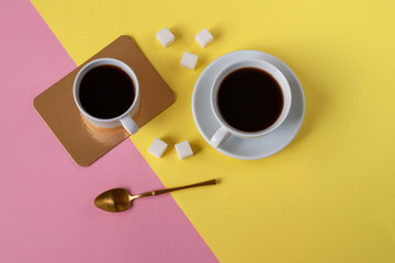 Cups of coffee on colored backgrounds. View from above.