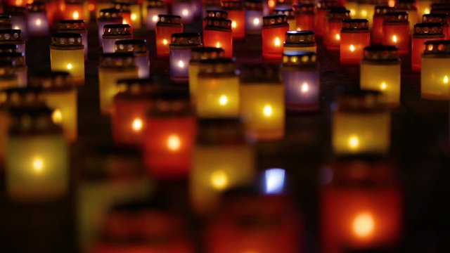 Many burning lanterns on memory. Feeling of sadness, pain and suffering. Laterns represent the memories of loved ones. People light lanterns to remember loved ones. Red round funeral burning candles.