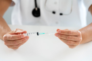 Syringe in the hand of a doctor