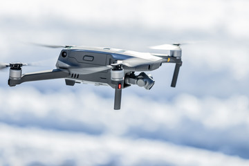 Drone in flight below eye level against a blurred background
