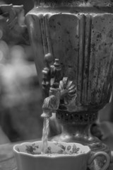 tea from the samovar is poured into an old porcelain Cup