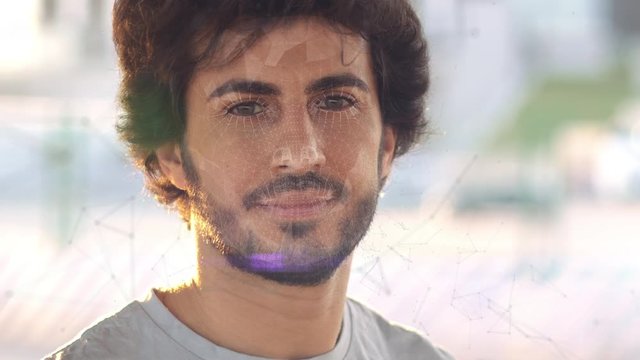 Face scanning. Biometric verification. The concept of a new technology for face recognition on a polygonal mesh. A young guy with a polygonal mesh on his face.