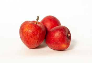 Red apples near a vase of lavender