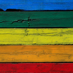 square bright textured background from old wood cracked planks painted in different colors of the rainbow
