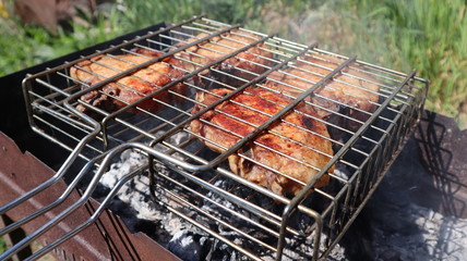 Pork steaks cooked on a charcoal grill outdoors