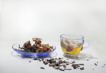 hot tea and dry tea leaf with rose petals