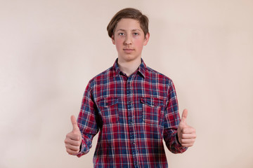 Fototapeta premium Handsome young man shows fingers up
