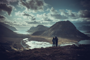 Fototapeta premium trekking on the Lofoten islands, a couple on top of a mountain range