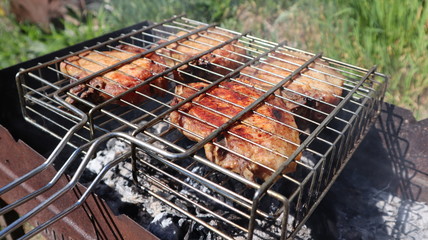 Pork steaks cooked on a charcoal grill outdoors