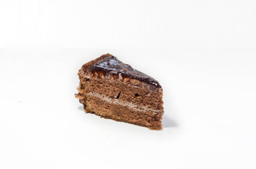 a piece of chocolate cake on a white background