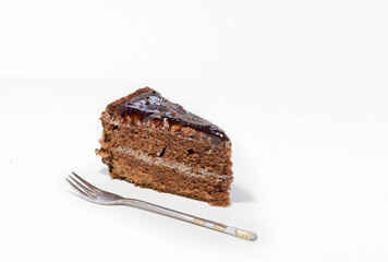 a piece of chocolate cake on a white background