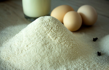 ingredients for baking cake at home: cinnamon, cloves, flour, sugar, butter, eggs and milk