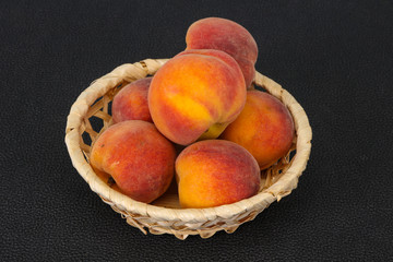 Peach heap in the wooden basket